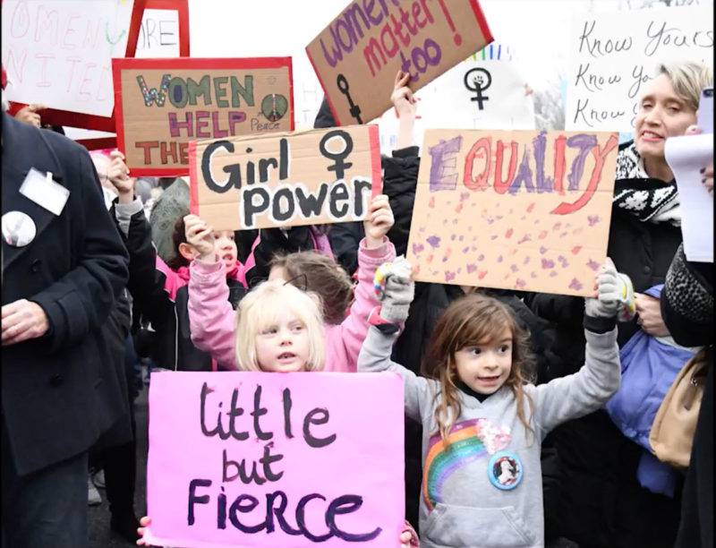 A group of children holding signs that say little girls are fierce.