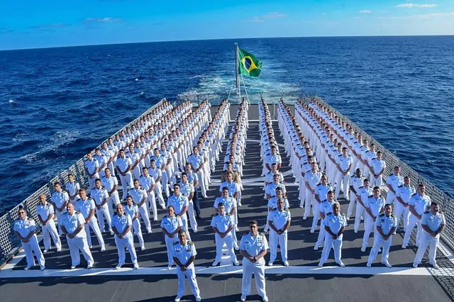 A group of sailors standing on the deck of a ship.