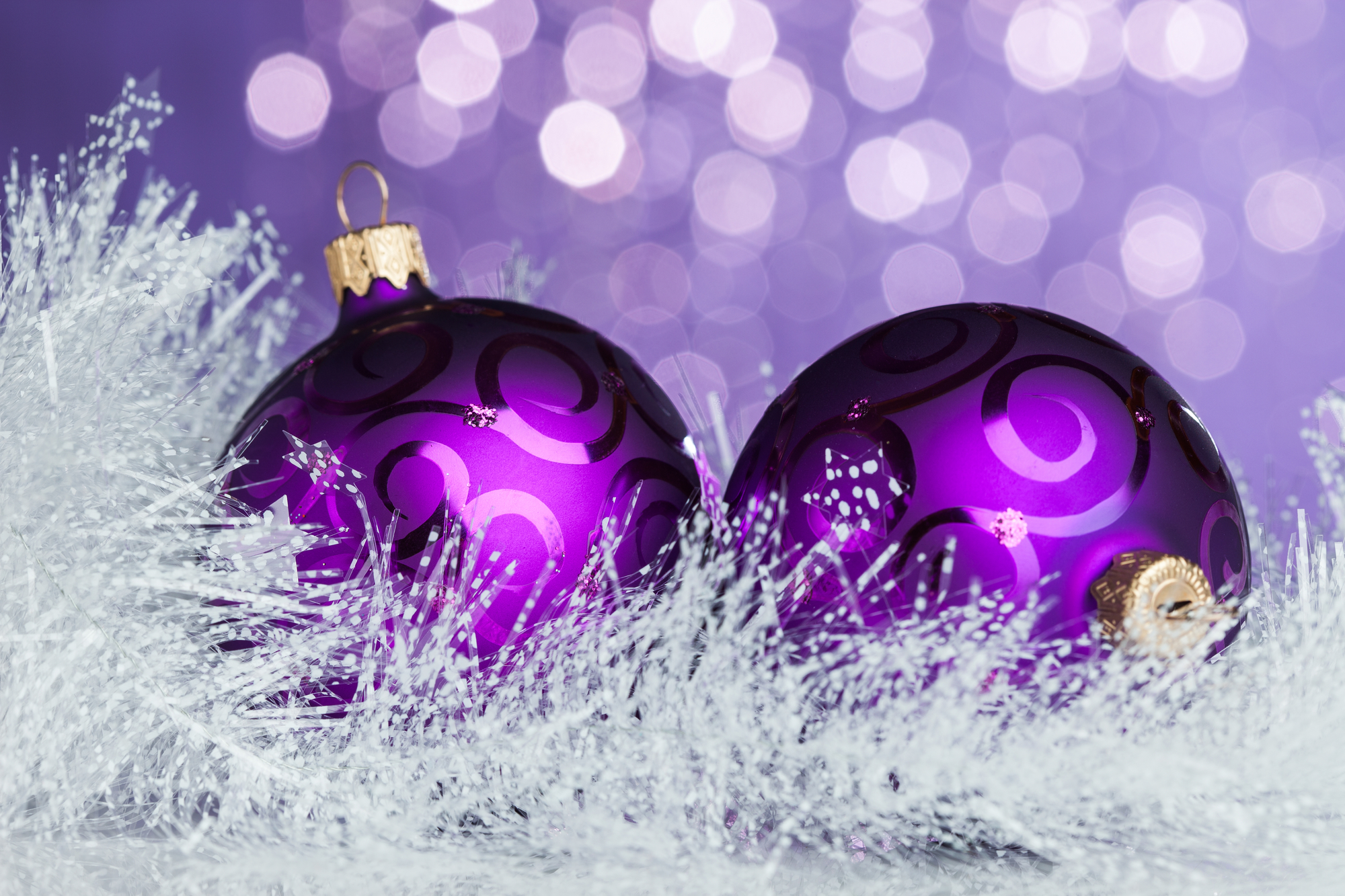 Two purple christmas balls on a white background at 34 Market Place.