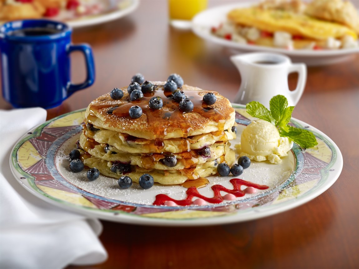 Enjoy delicious blueberry pancakes with syrup at Miss Shirley's Cafe. Don't forget to take advantage of the convenient parking for your next visit.