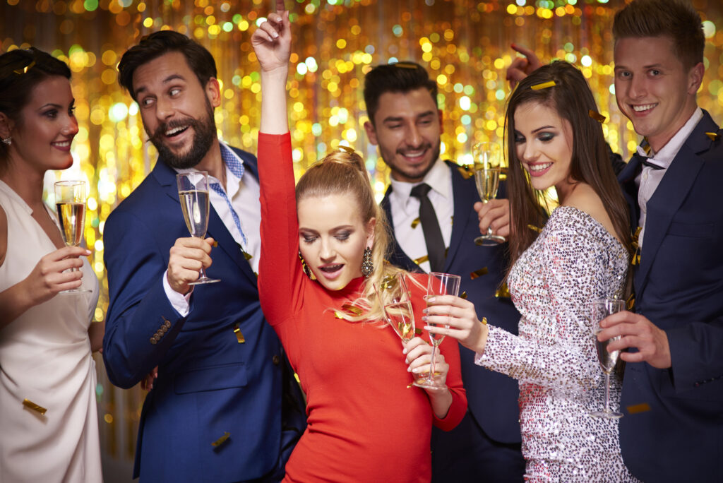 A group of people holding champagne glasses at a Baltimore NYE celebration at Power Plant Live.