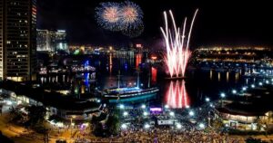 A mesmerizing view of a fireworks display over Baltimore's Inner Harbor during a holiday voyage in 2023.