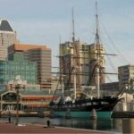 A tall ship docked in a harbor.