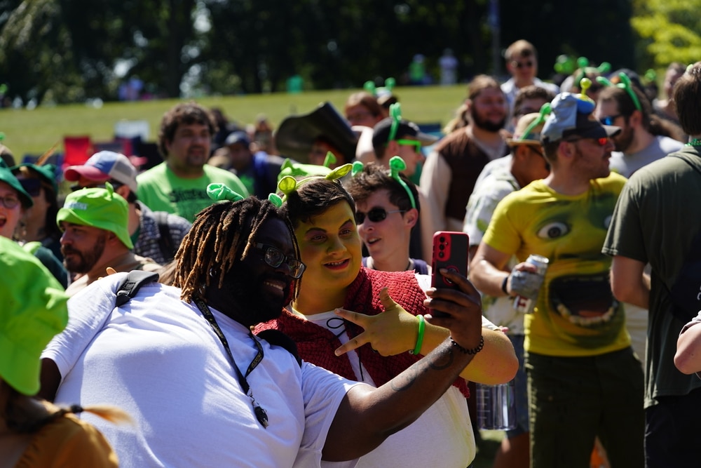 A crowd of people wearing green hats at a Baltimore Soundstage rave, reminiscent of Shrek.