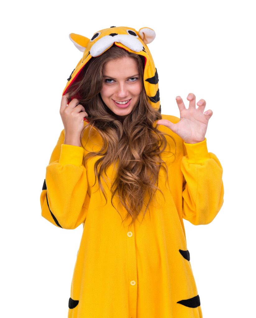 A woman in a yellow tiger costume posing at a pajama crawl event.