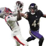 A football player in a Patriots uniform catches a pass while a Ravens defender attempts to block him during a game.